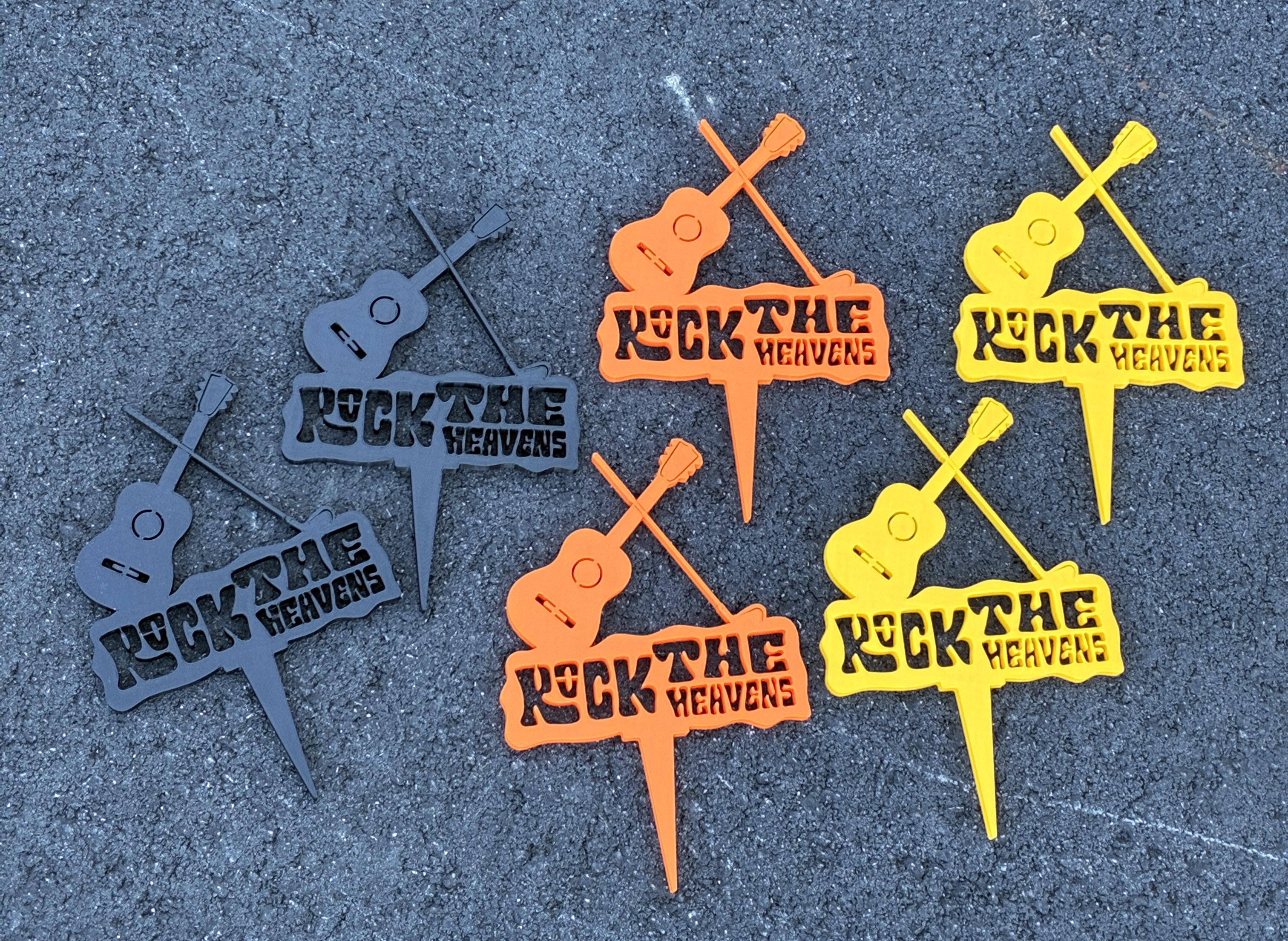 Colorful custom Pebble Beach tee markers in charcoal, orange, and yellow